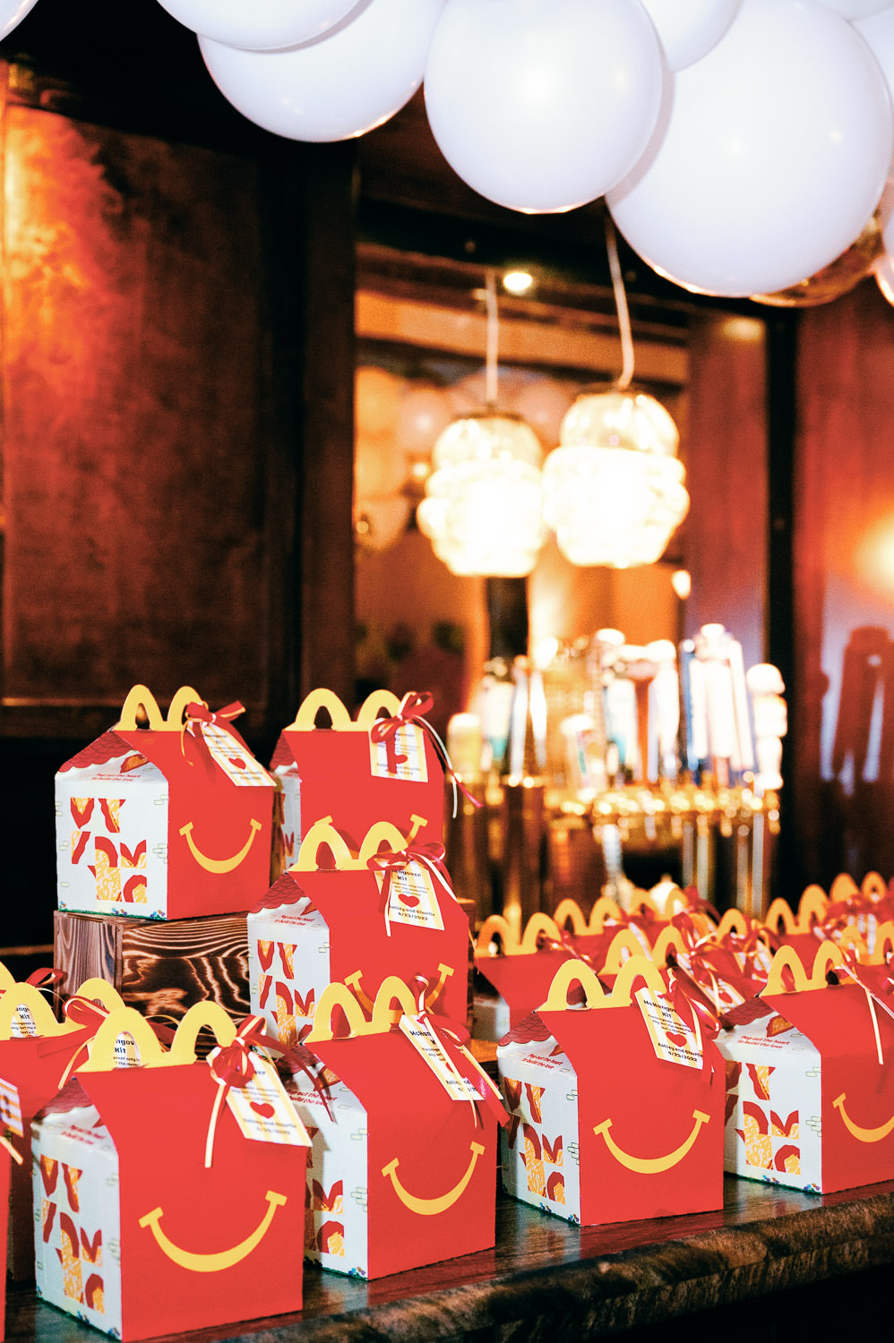 McDonalds happy meals are stacked at an wedding afterparty