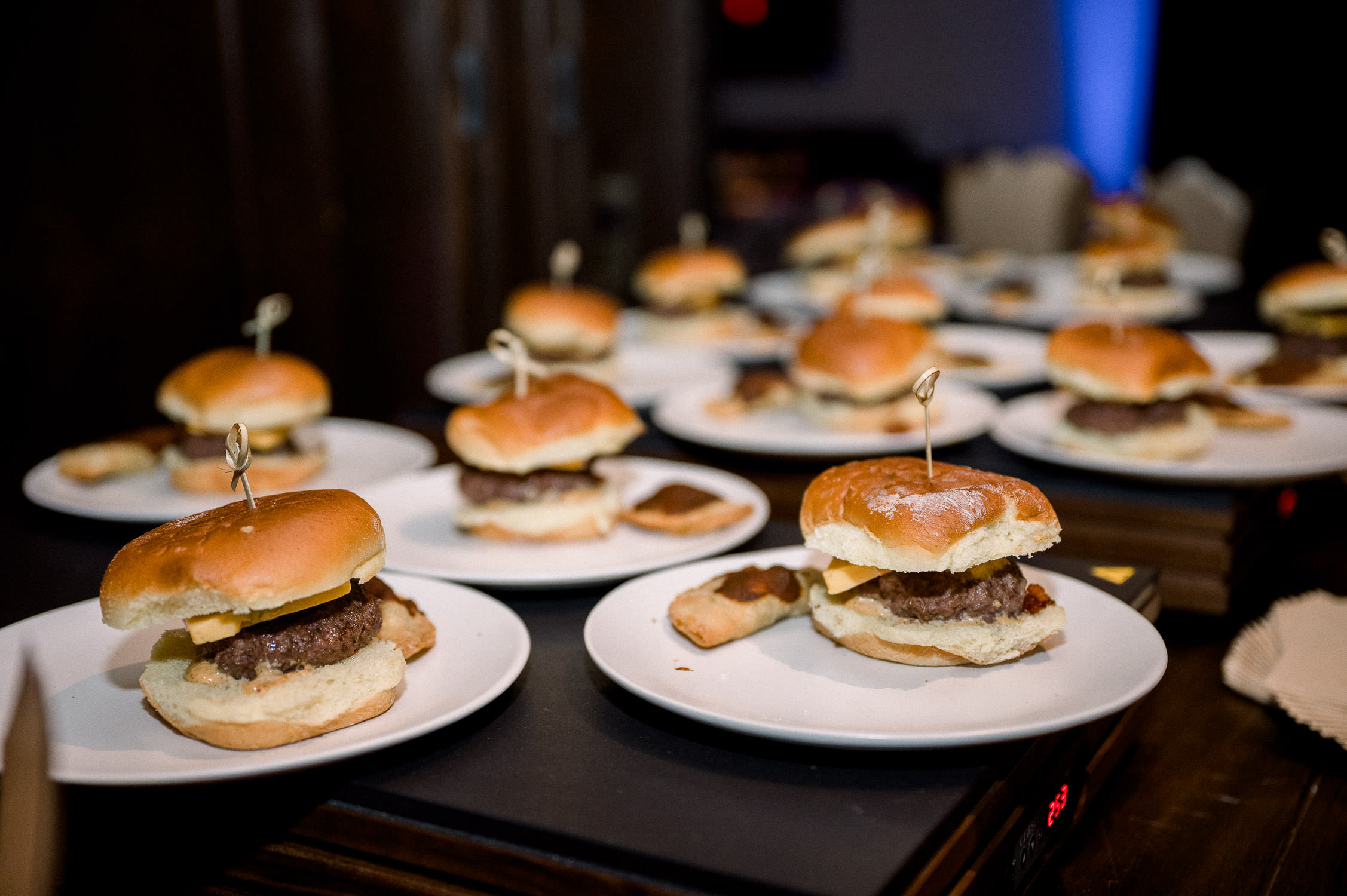 Late night mini burgers set up in a row.