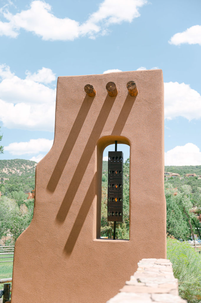 Adobe gate in front of blue sky in Santa Fe New Mexico.
