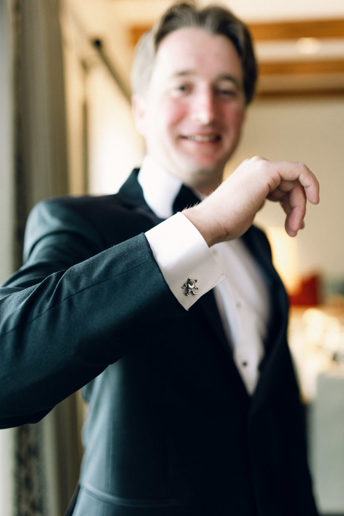 Groom shows off his cufflinks.