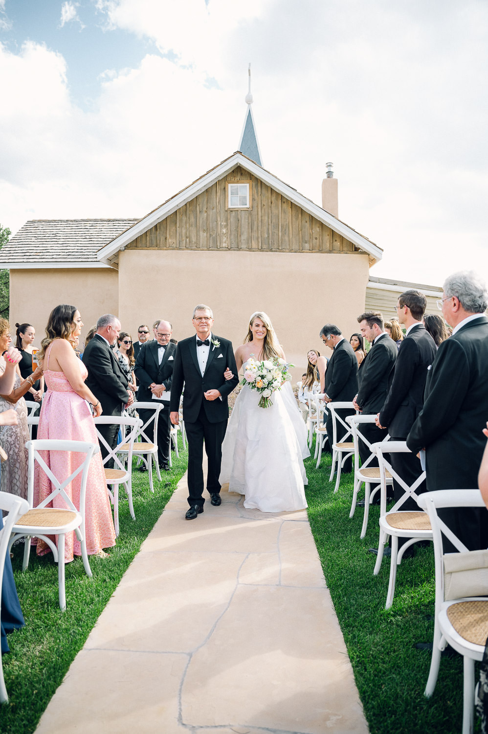 Elegant bride and father walking down the aisle at Bishop's Lodge in Santa Fe.